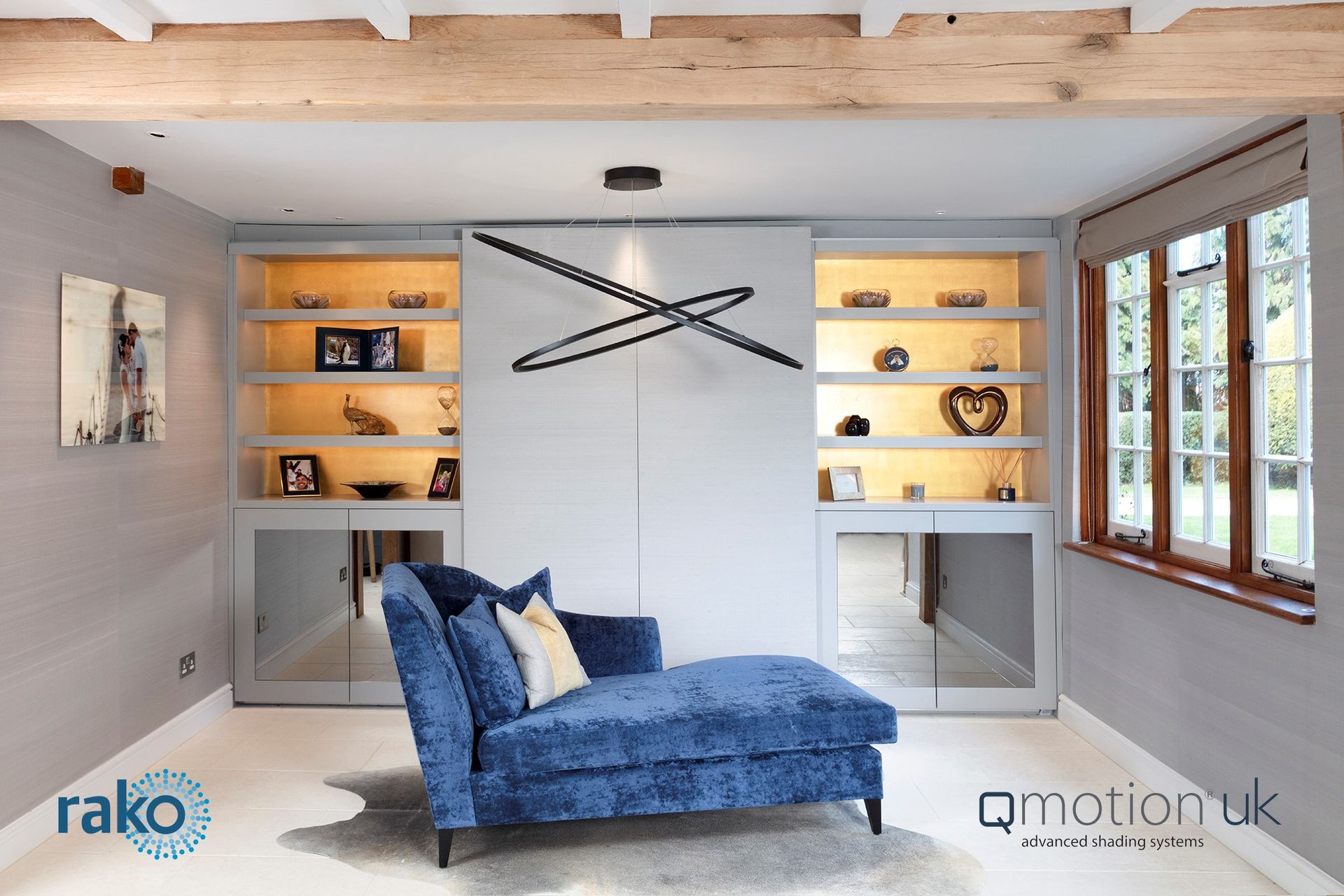 Cozy room with a blue chaise lounge, built-in shelves, and a decorative light fixture.