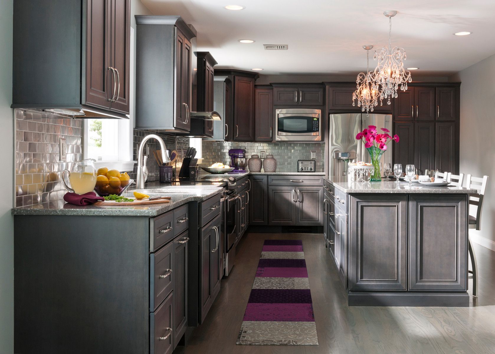 A kitchen with purple cabinets and a purple rug