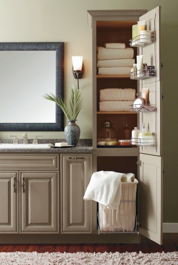 A bathroom with a large cabinet filled with towels