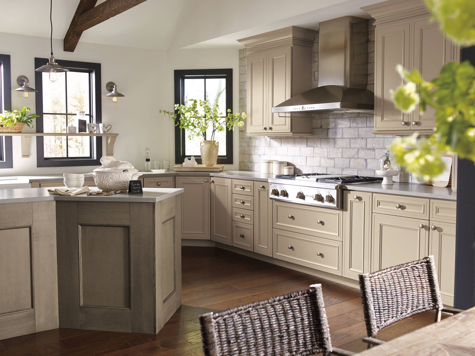 A kitchen with stainless steel appliances and wicker chairs