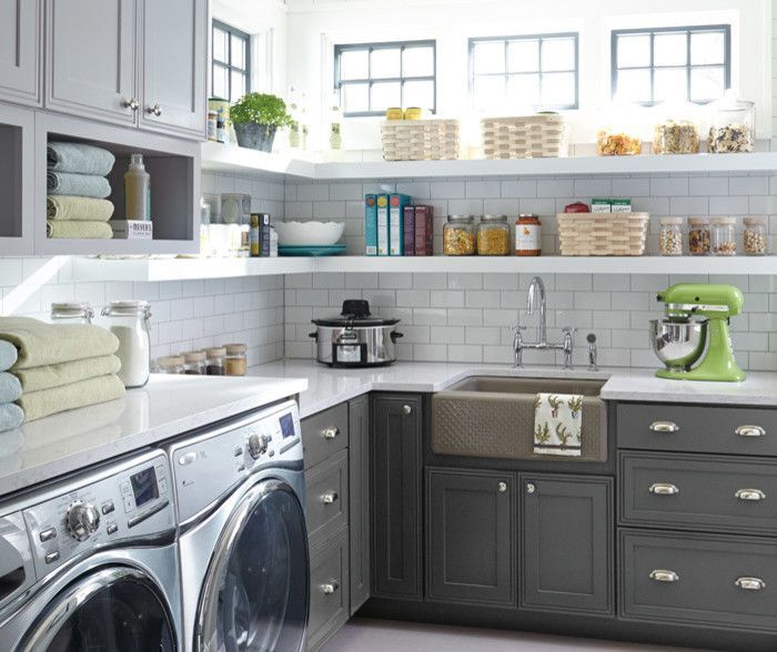 A laundry room with a washer and dryer and a sink.