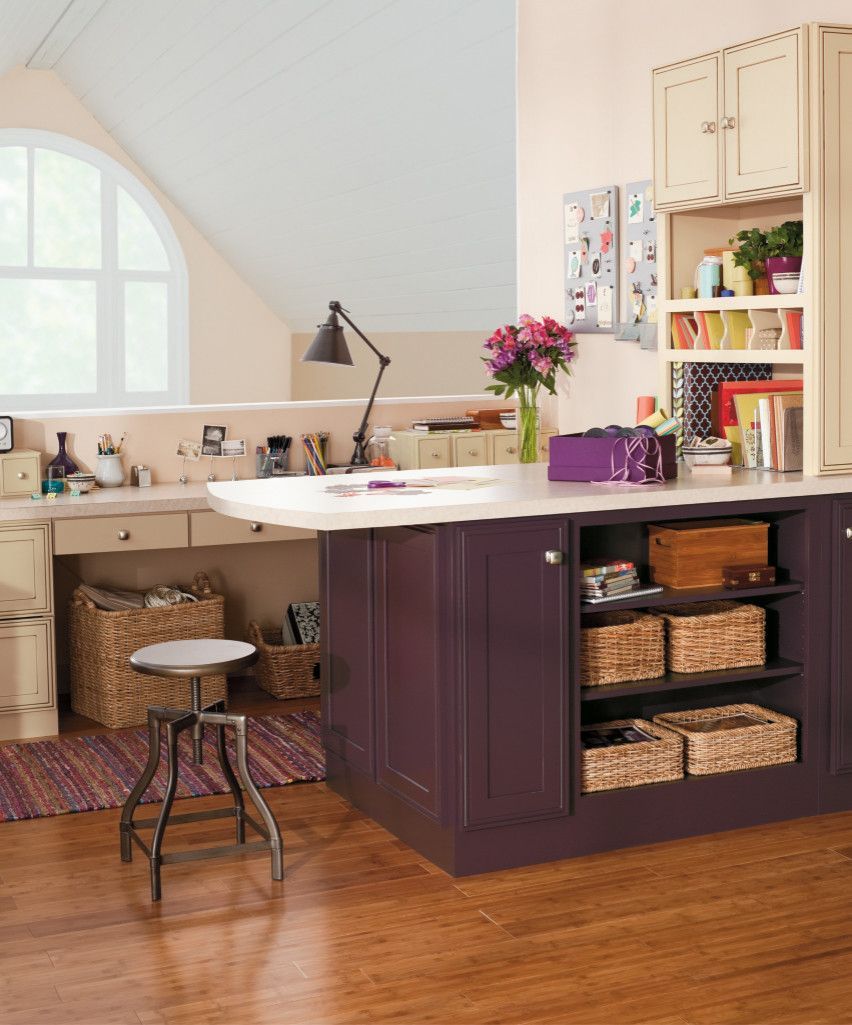 A room with purple cabinets and wicker baskets