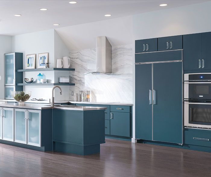 A kitchen with blue cabinets and stainless steel appliances