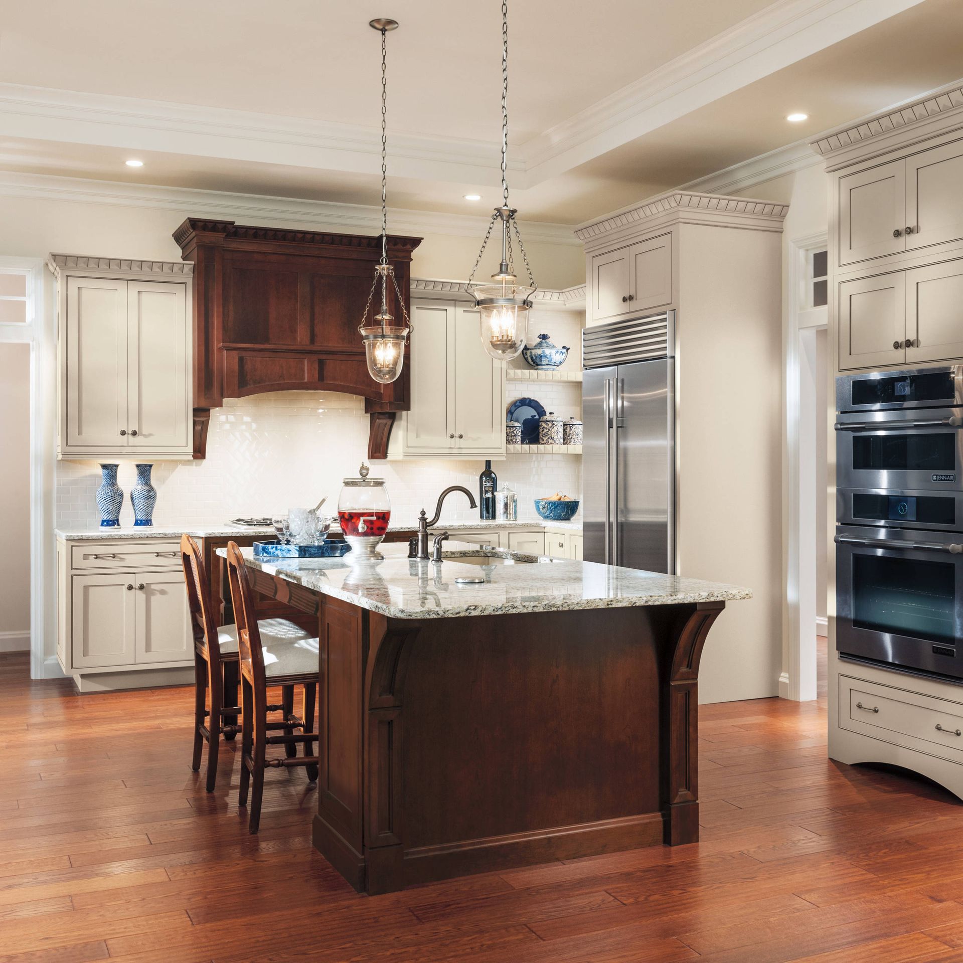 A kitchen with white cabinets and stainless steel appliances