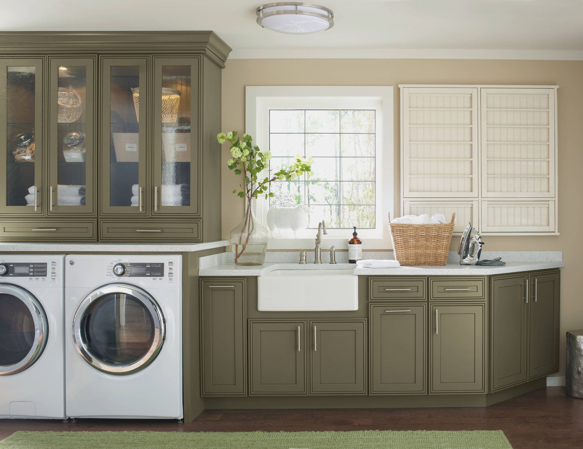 A laundry room with a washer and dryer and a sink