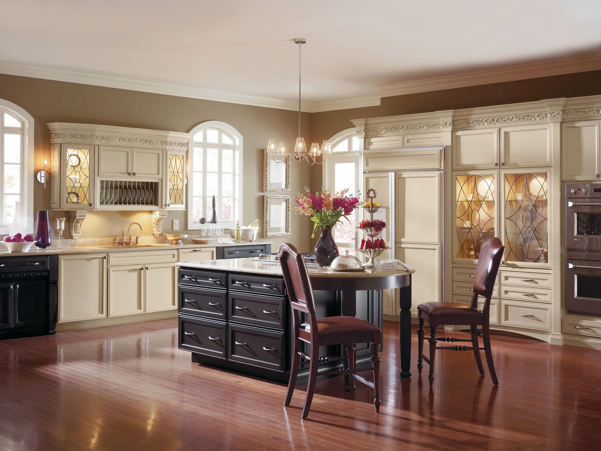 A kitchen with white cabinets and a large island in the middle