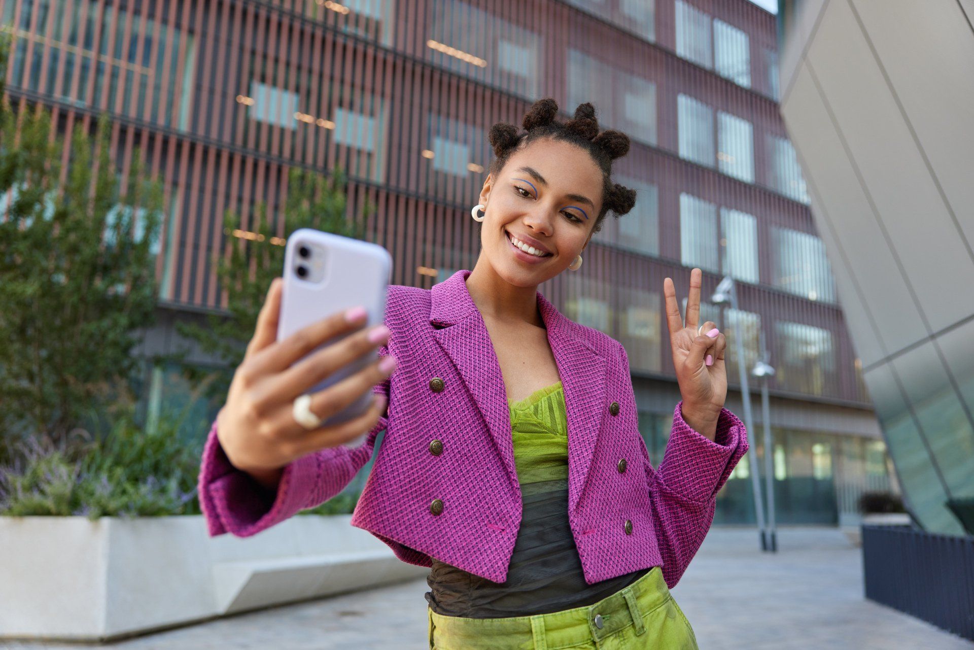 Chica atractiva en ropa de moda creats influencia contenido muestra el signo de la paz en la cámara