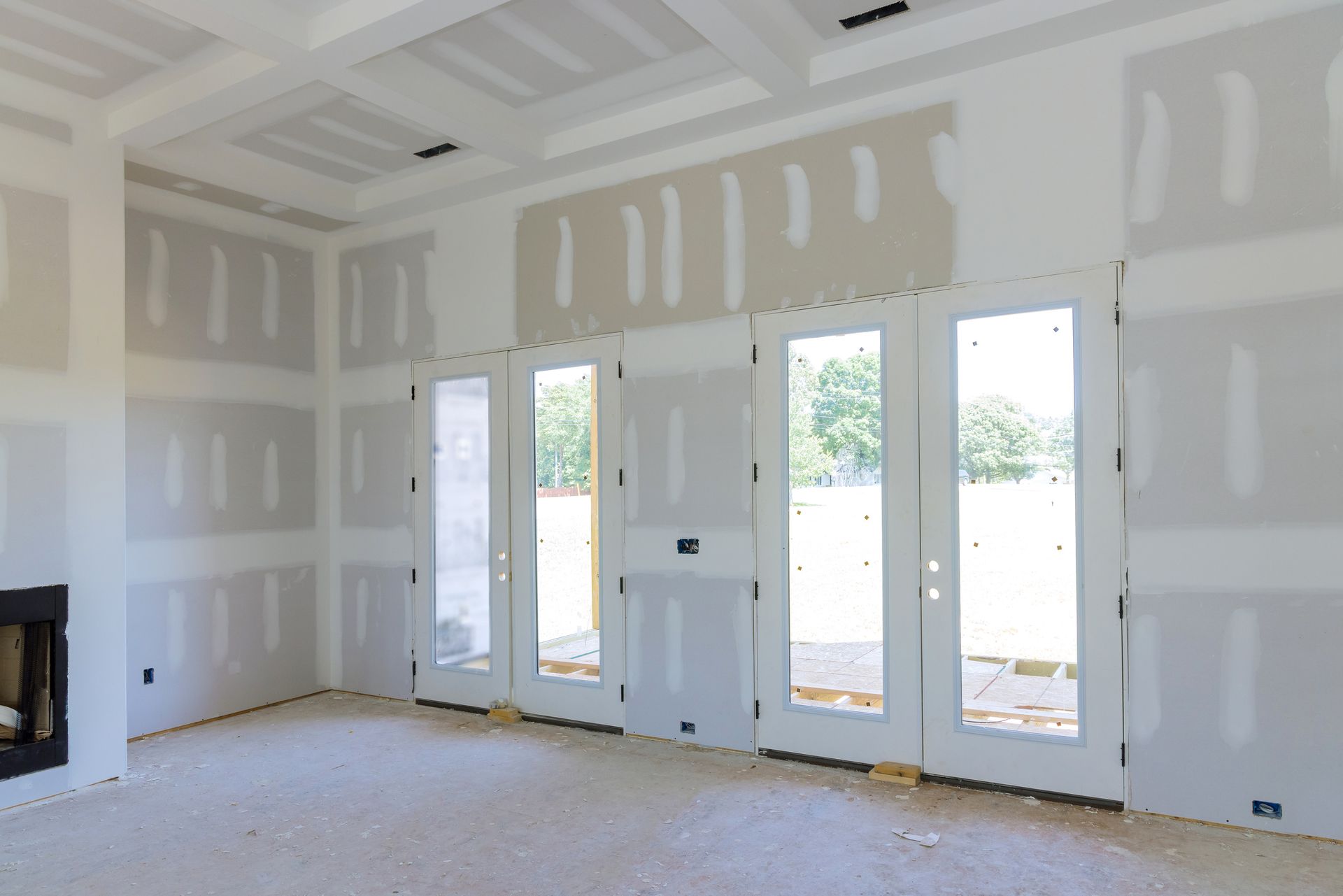 Applying finishing putty on walls, showcasing the work of a skilled residential drywall contractor.