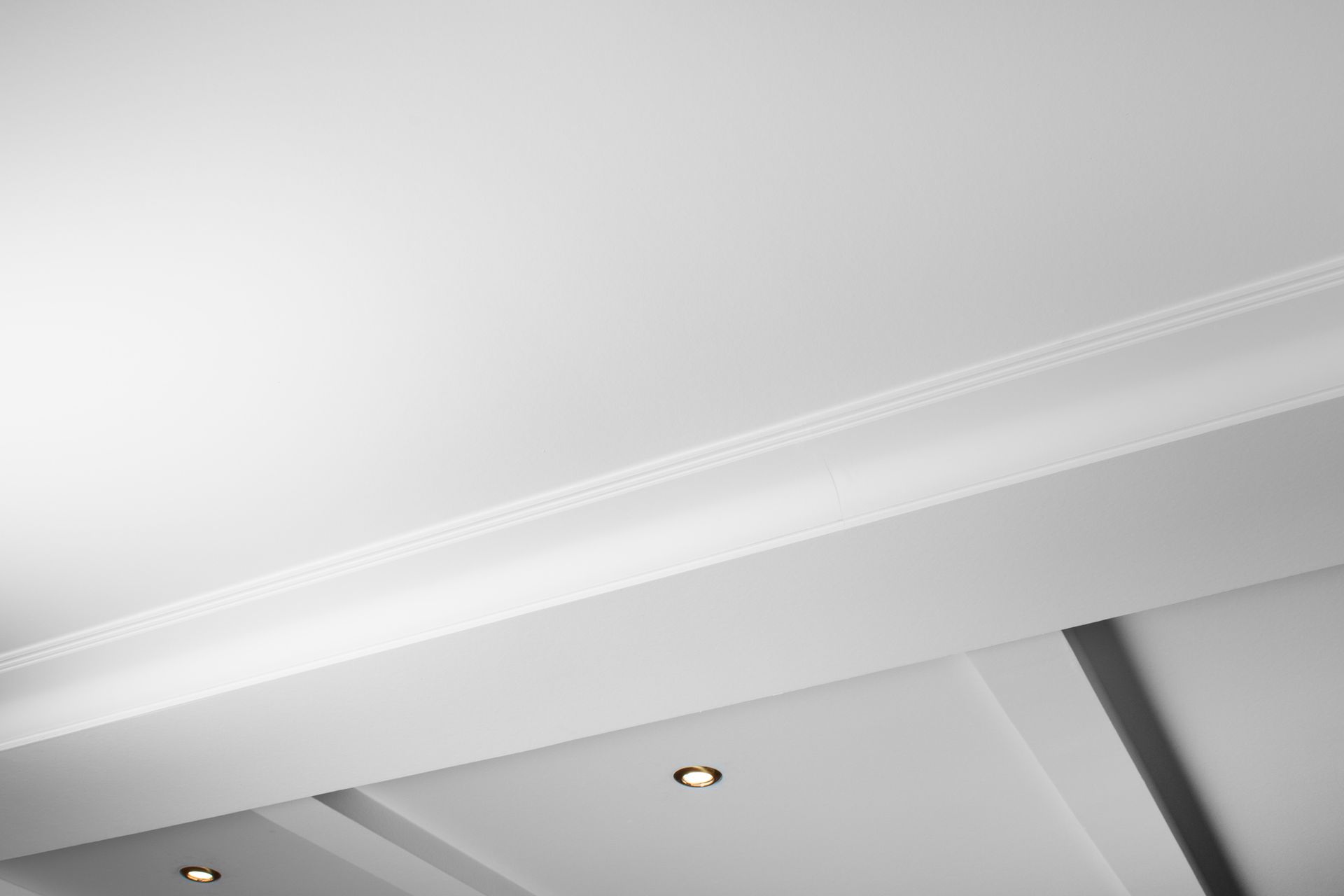 White ceiling with crown molding and recessed lighting. White ceiling with crown molding and recessed lighting.