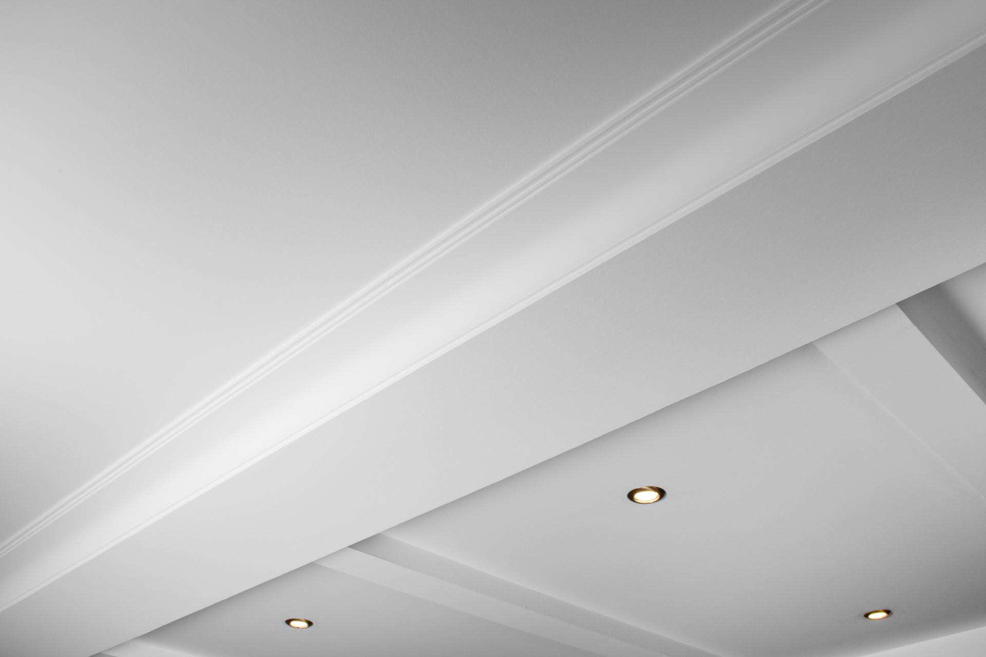 White ceiling with recessed lighting and crown molding. White ceiling with recessed lighting and crown molding.