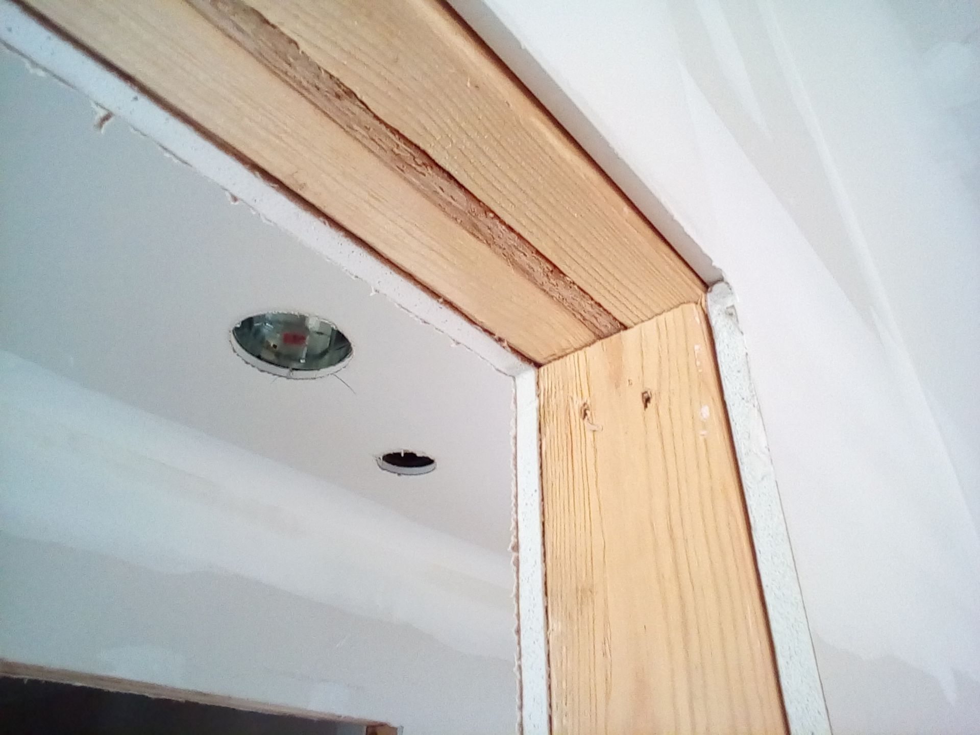 Wooden door frame construction with exposed wood and drywall. Wooden door frame construction with exposed wood and drywall.