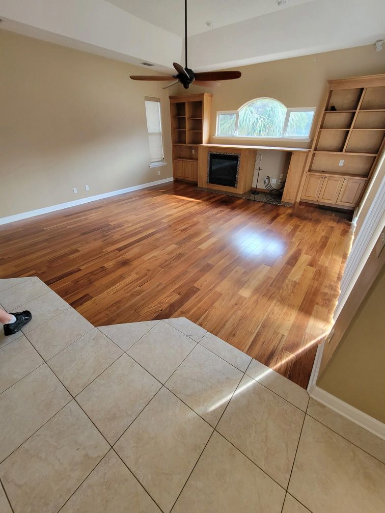 A large room with a carpeted floor and a blue wall.