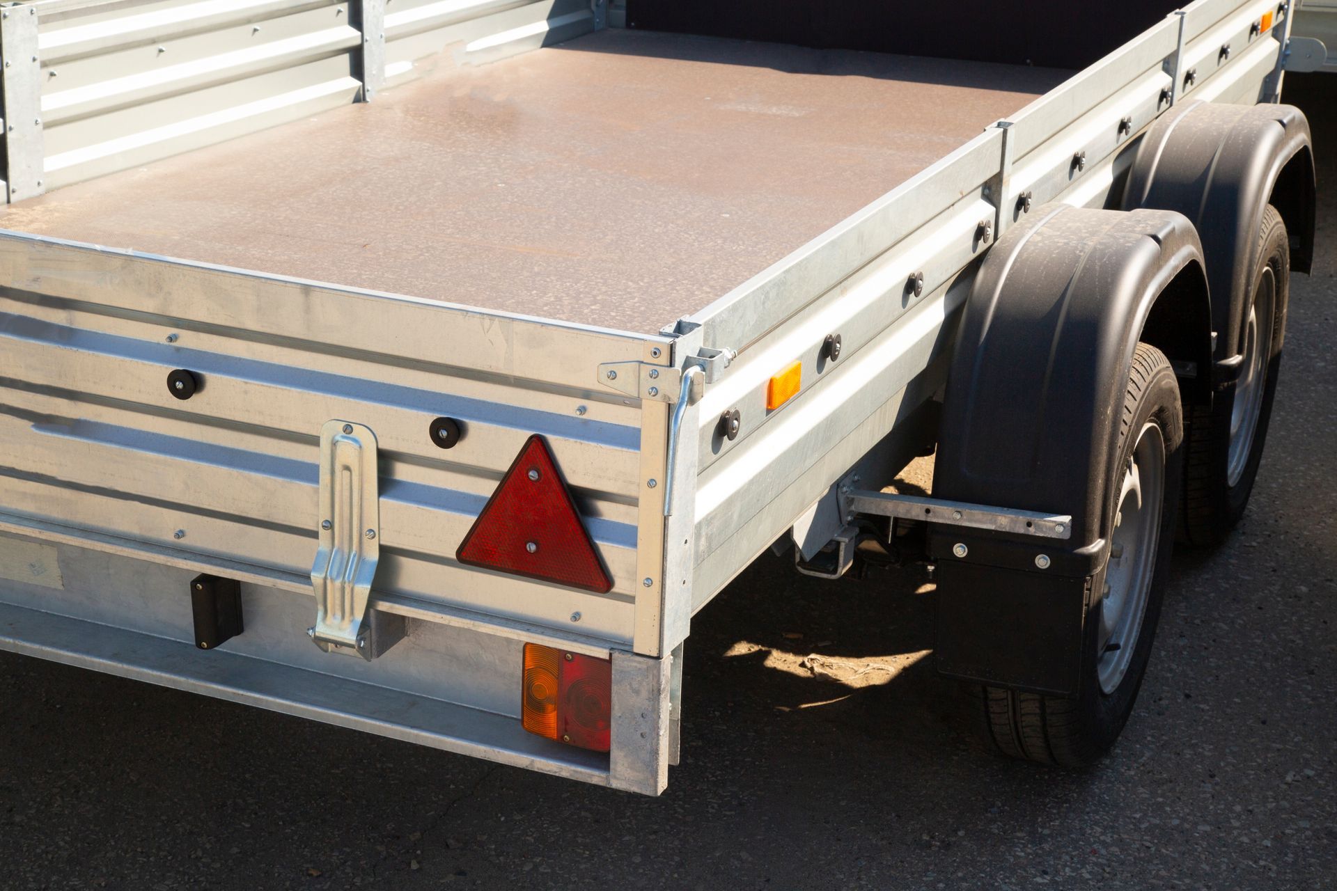 A utility cargo trailer behind vehicle, showcasing professional trailer repair service. A utility cargo trailer behind vehicle, showcasing professional trailer repair service.