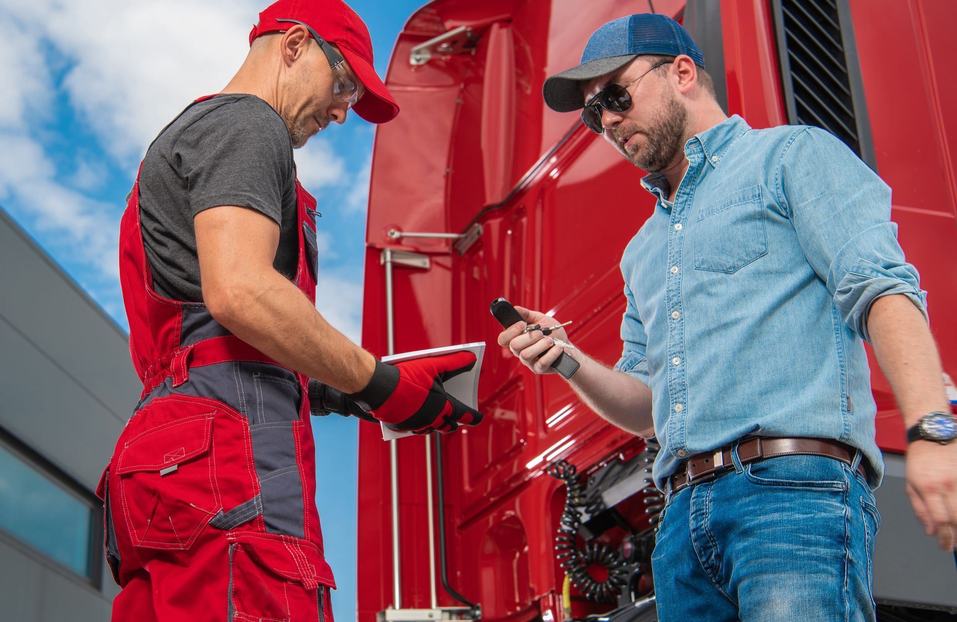 A male trucker explains to a truck center worker what happened to his car.
