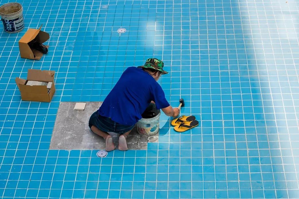 A Man on the Floor of a Swimming Pool — Billabong Pool Service & Supply Pty Ltd in Buderim, QLD