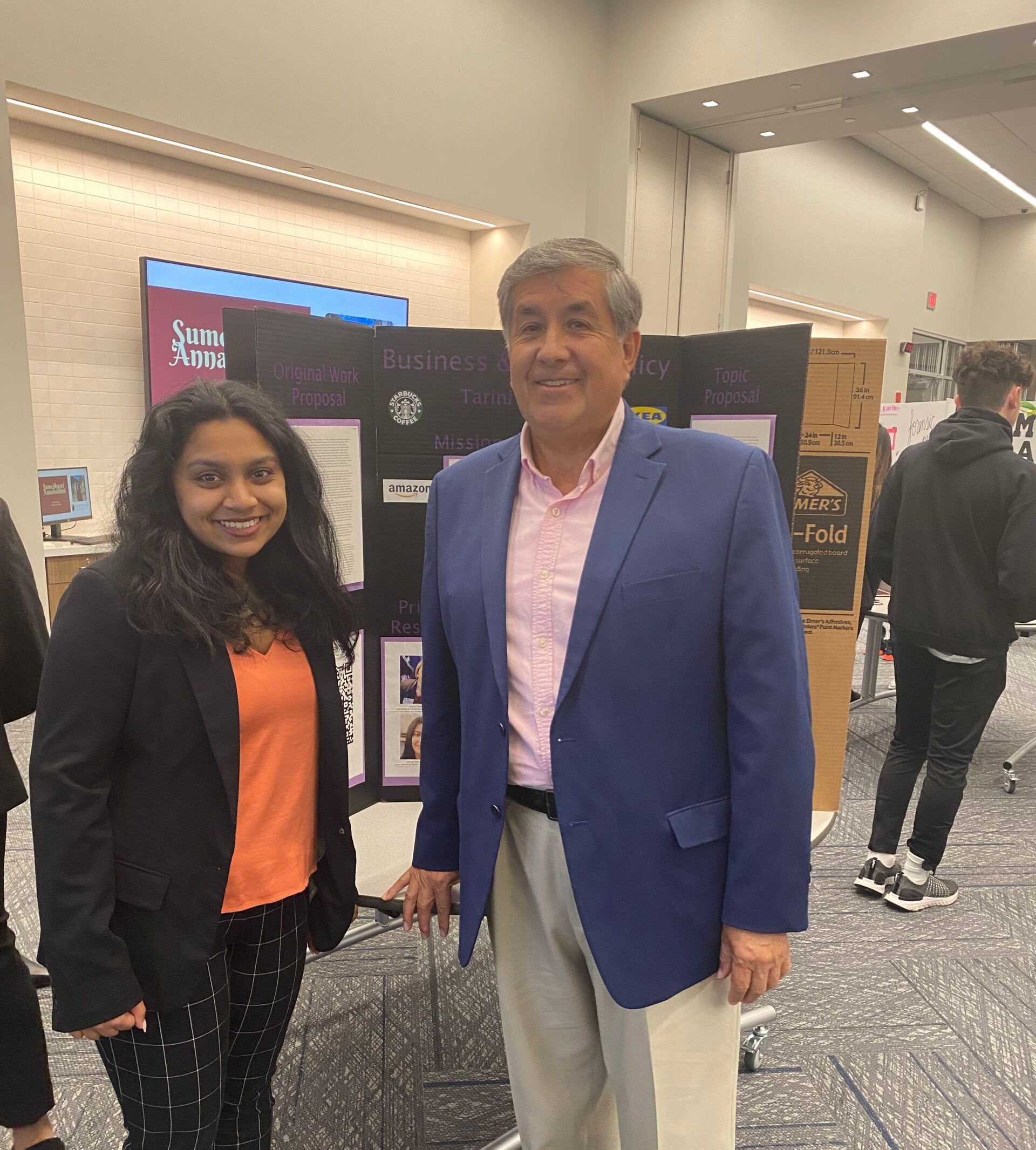 A man and a woman are standing next to each other in a room.