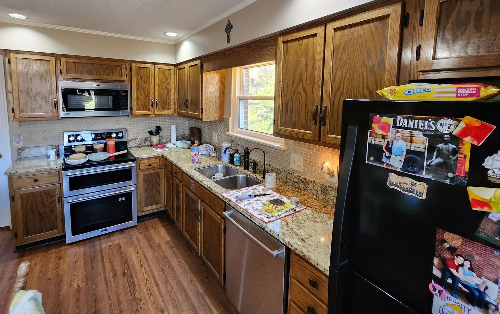 Kitchen with wood cabinets, stainless steel appliances, and granite countertops.