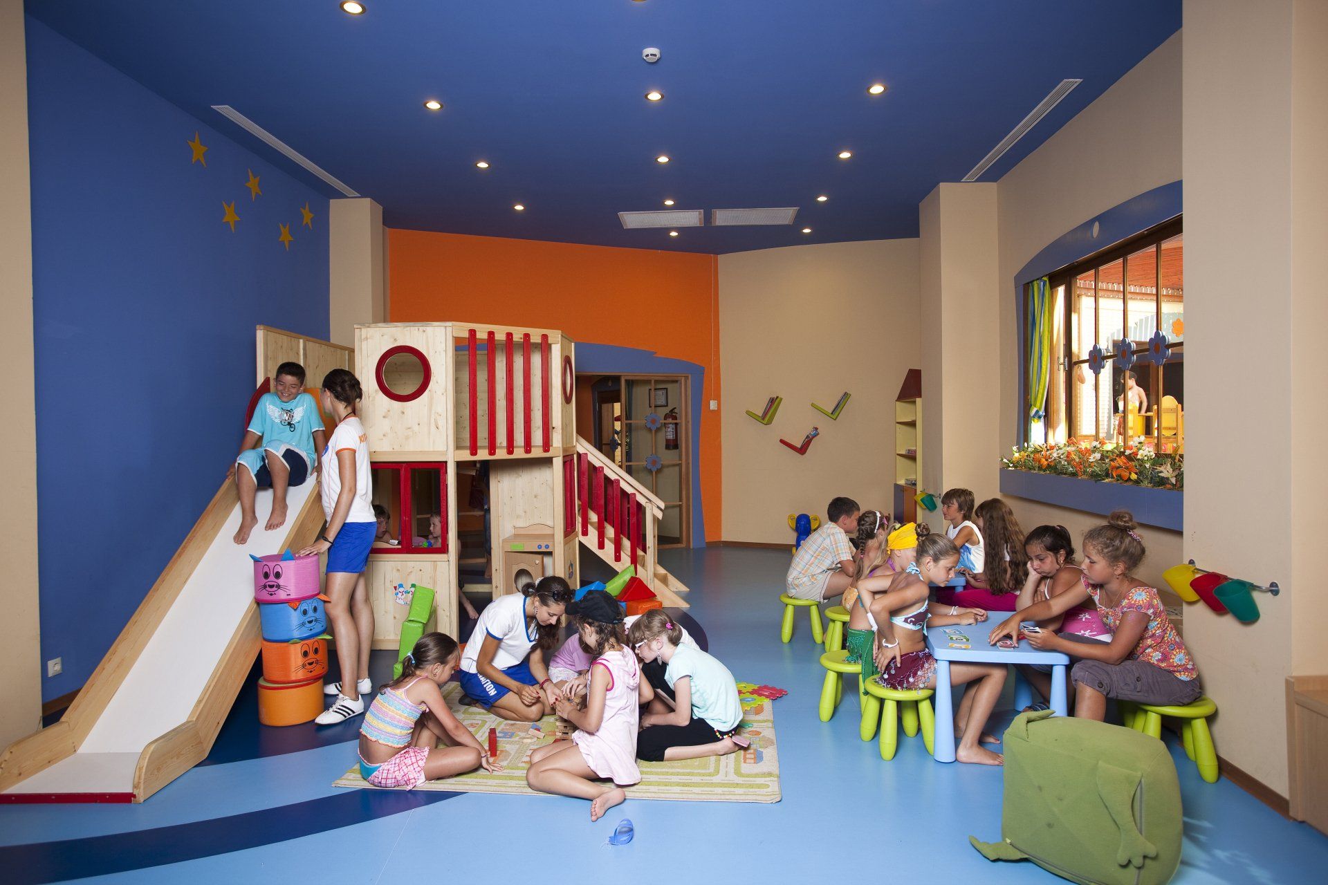 A group of children are playing in a play room.