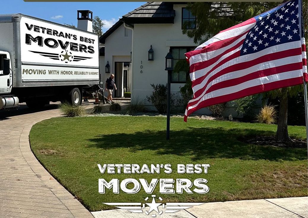 A Veteran's Best Movers truck is parked in front of a house.