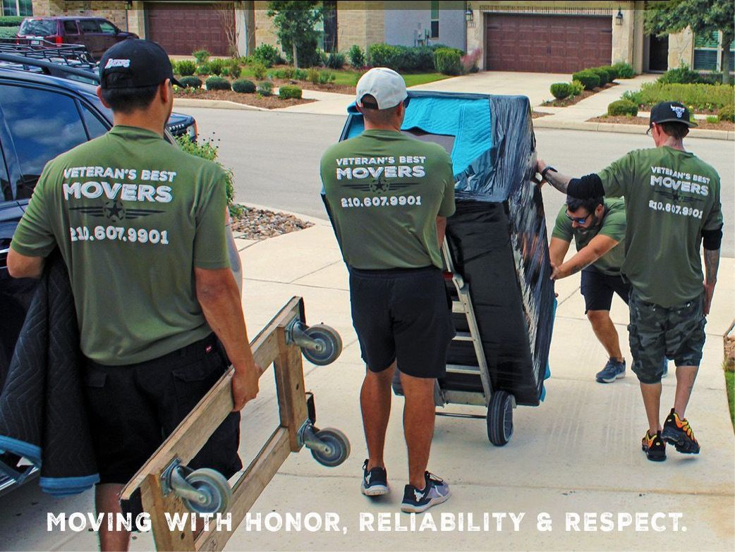 A group of men are carrying a couch down a street.