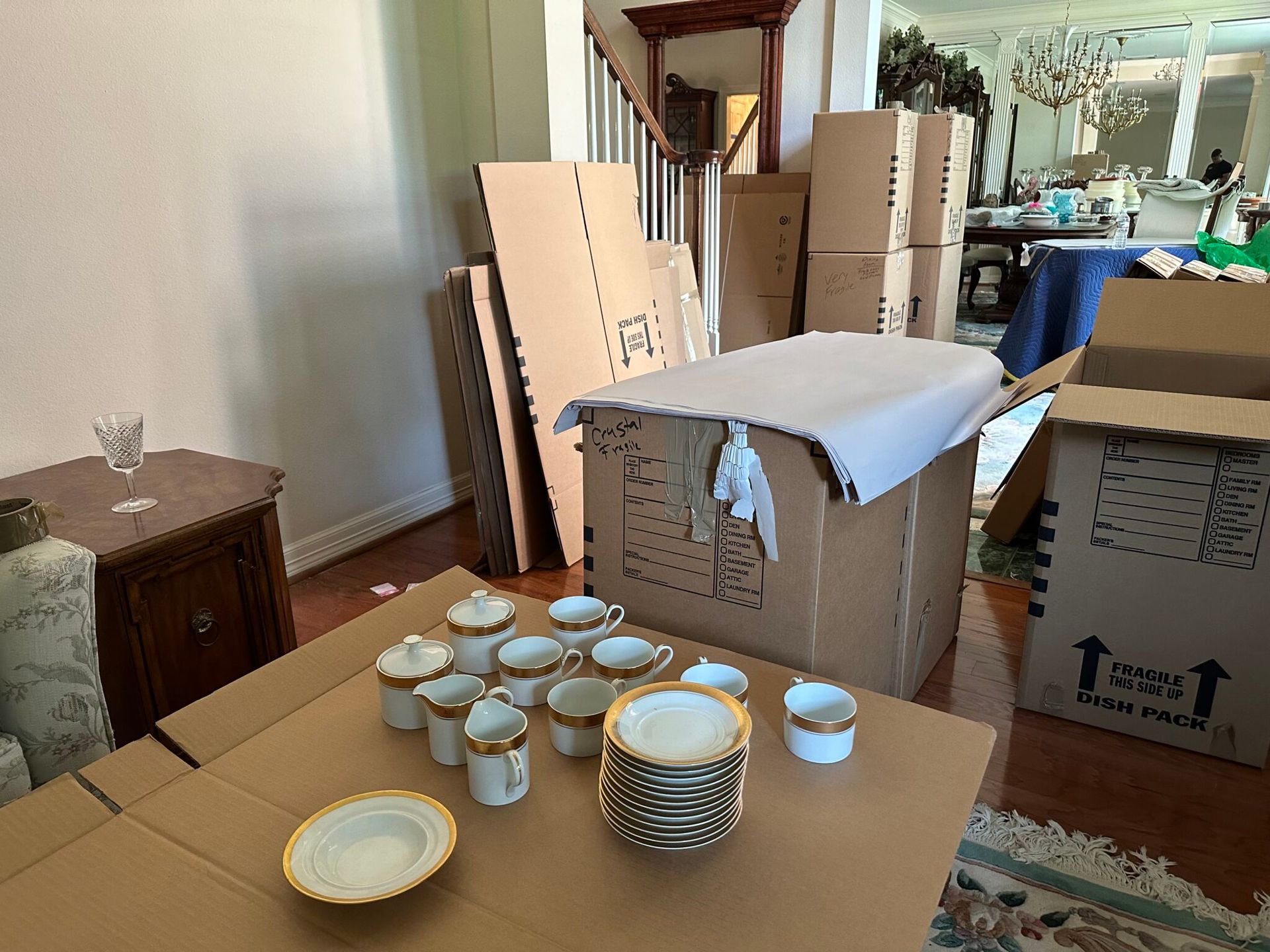 Boxes and dishes in a room, preparing for a move.