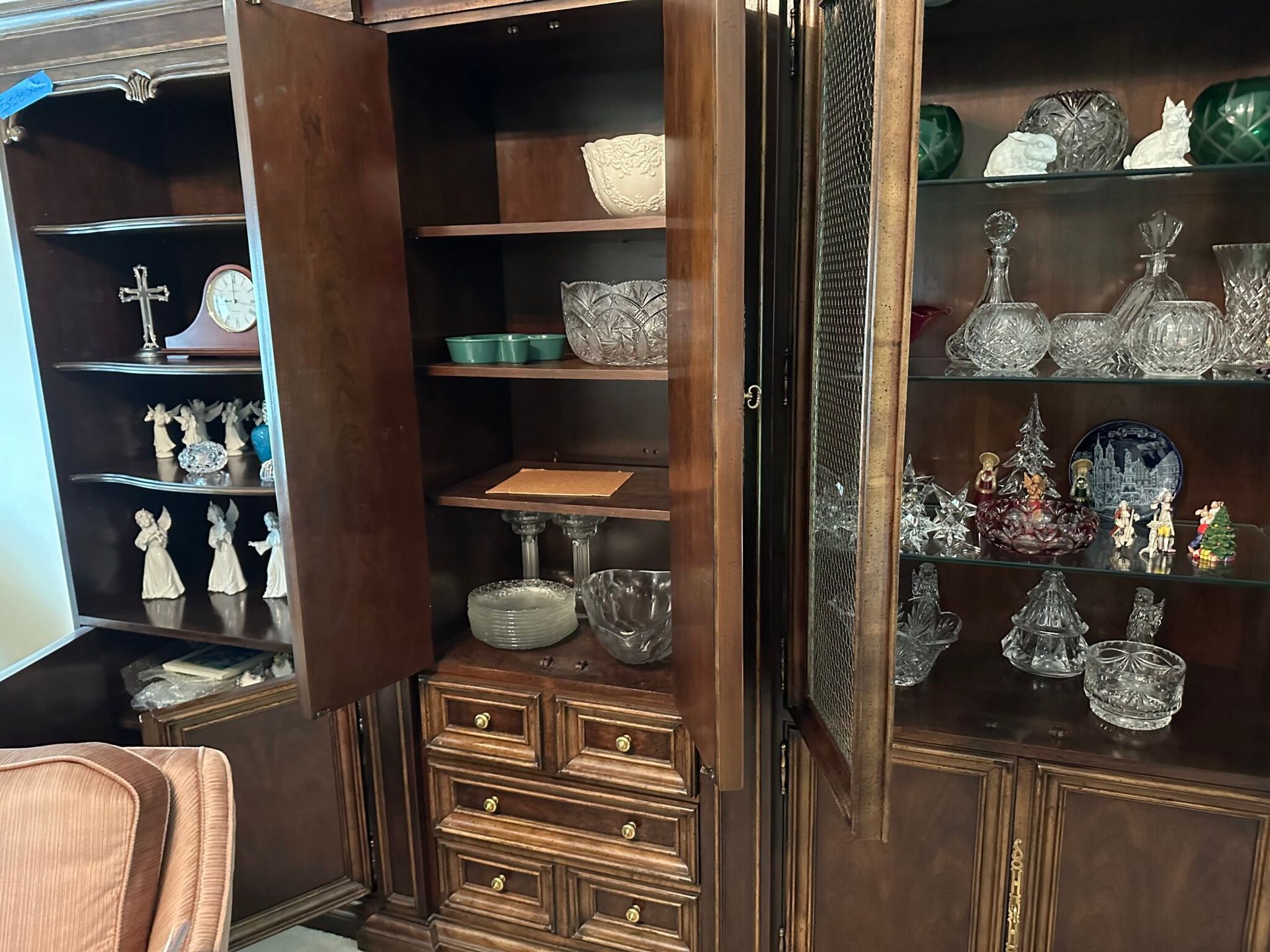 A living room filled with lots of glassware and a clock