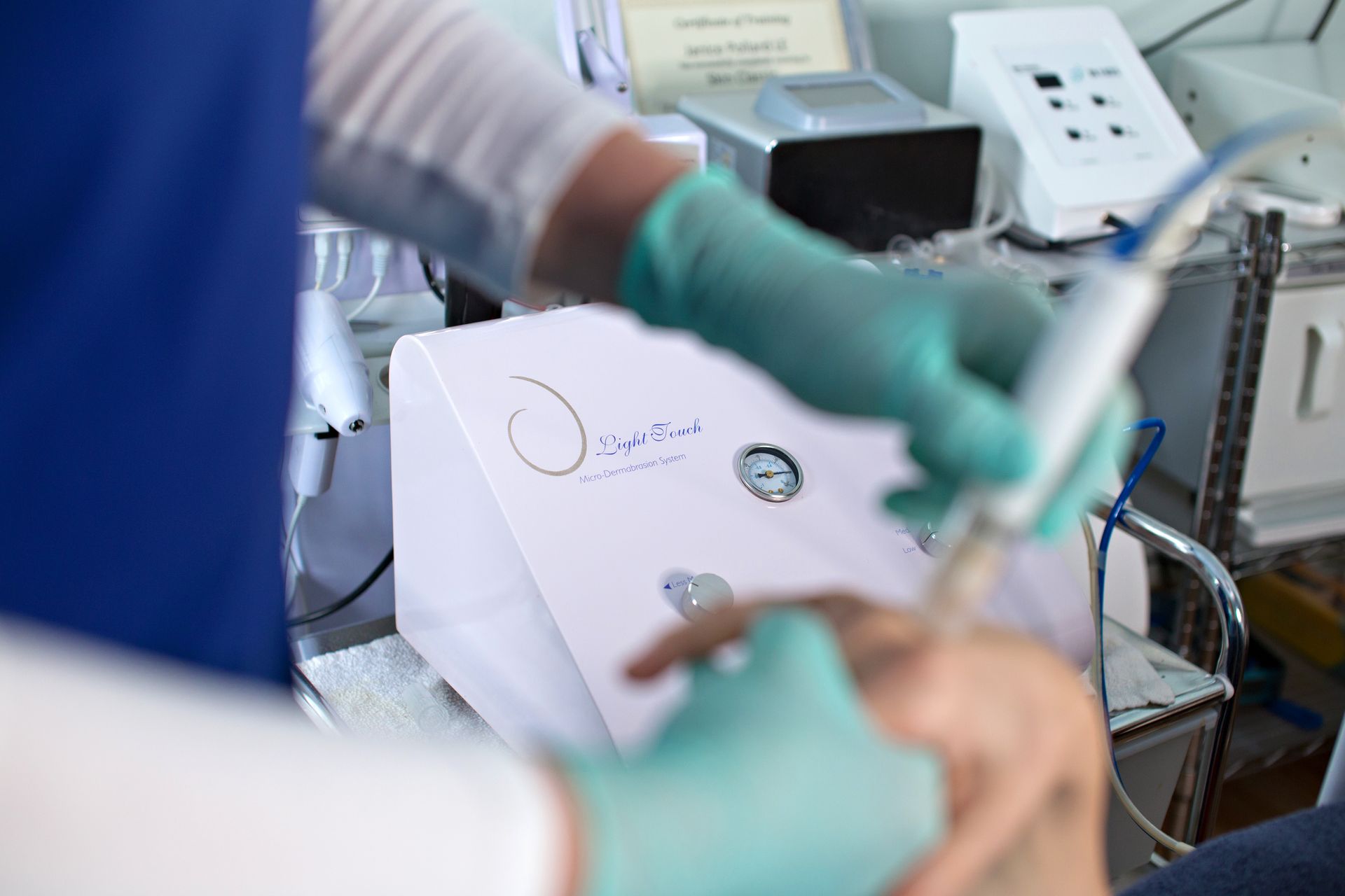A person is getting a tattoo on their face with a machine.