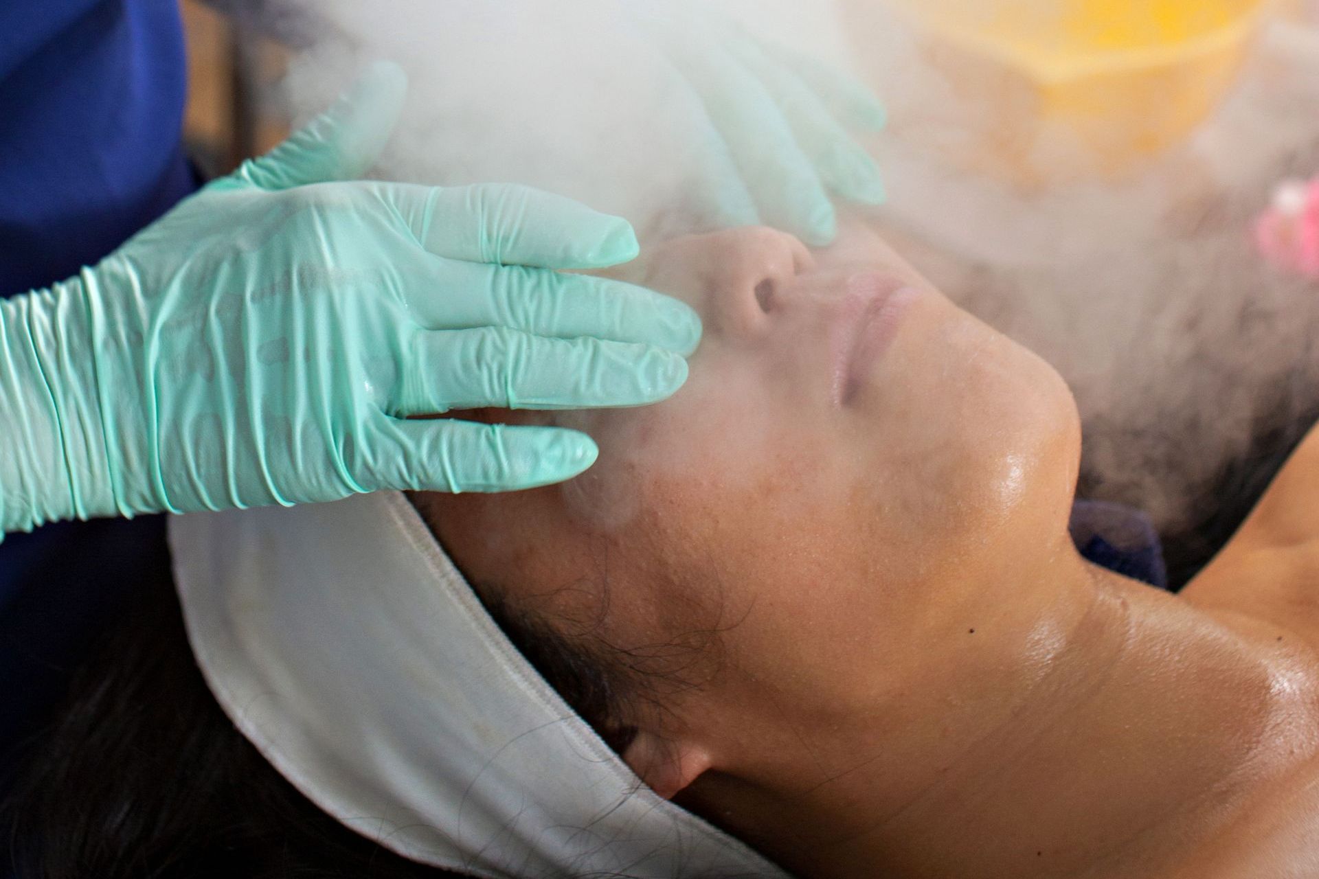 A woman is getting a facial treatment at a spa.