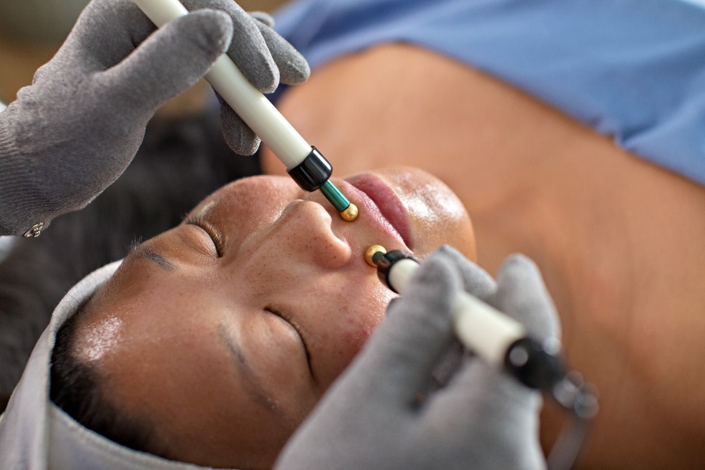A woman is getting a facial treatment at a spa.