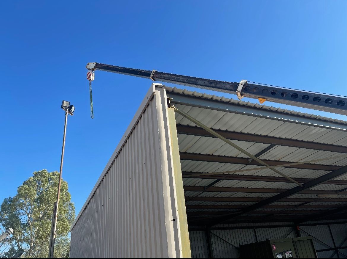 A crane is attached to the side of a building-Crane Hire in Alice Spring, NT