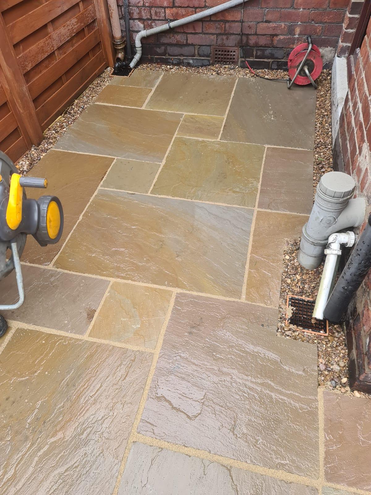 Fencing York Indian sandstone paving down side of house in York