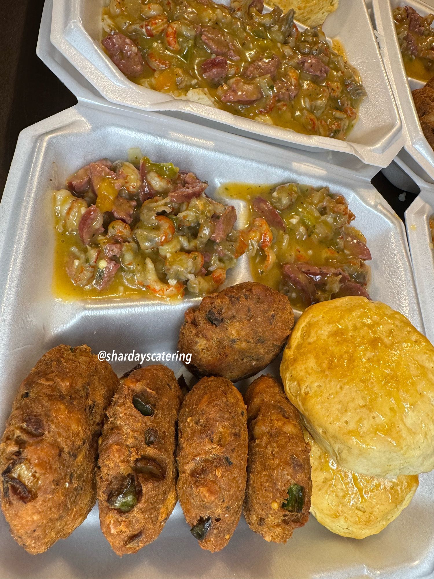 A styrofoam container filled with a variety of food.