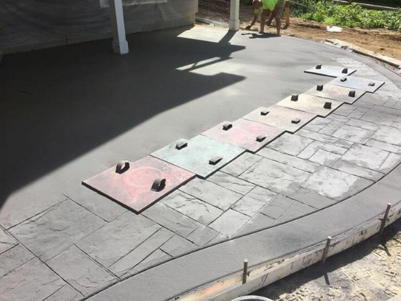 “Stamped concrete patio surface with pattern mats placed during decorative concrete installation for concrete services in Pine Hills, FL”