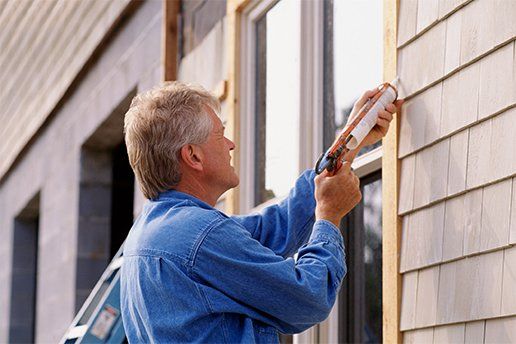 Window Repair — Man Putting Window Silicone Sealant in Port St Lucie, FL
