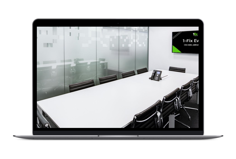 A laptop computer is displaying a conference room with a long table and chairs.