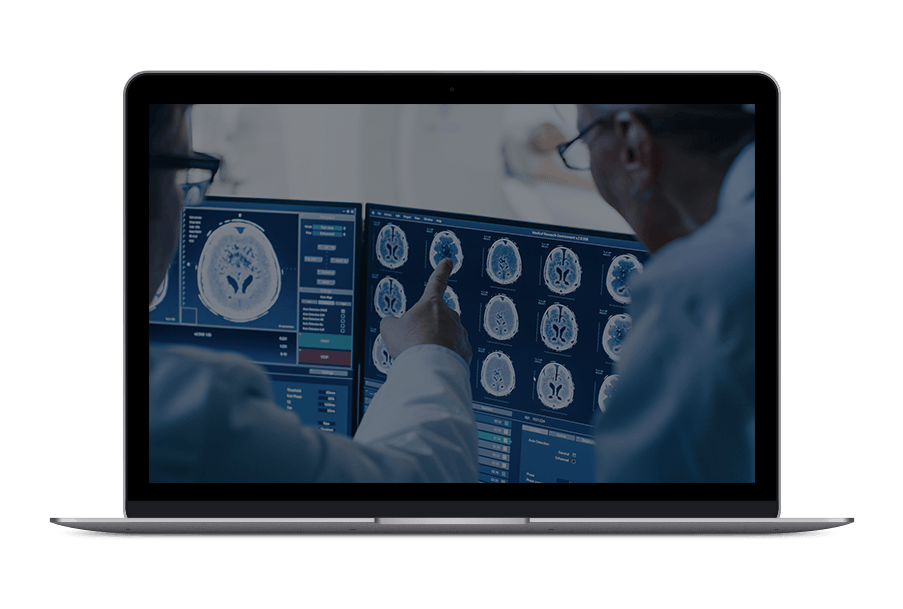 Two doctors are looking at a ct scan on a laptop computer.