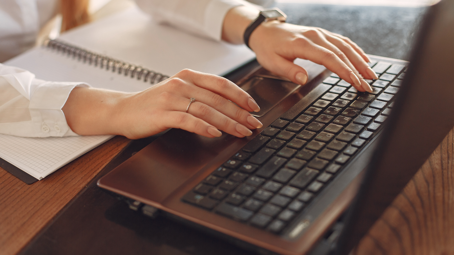 Photo of someone typing on a laptop keyboard 