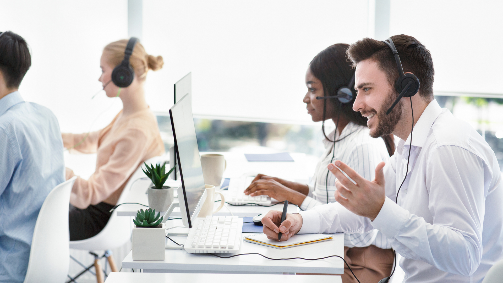 Photo of People on the phone with headsets in an office