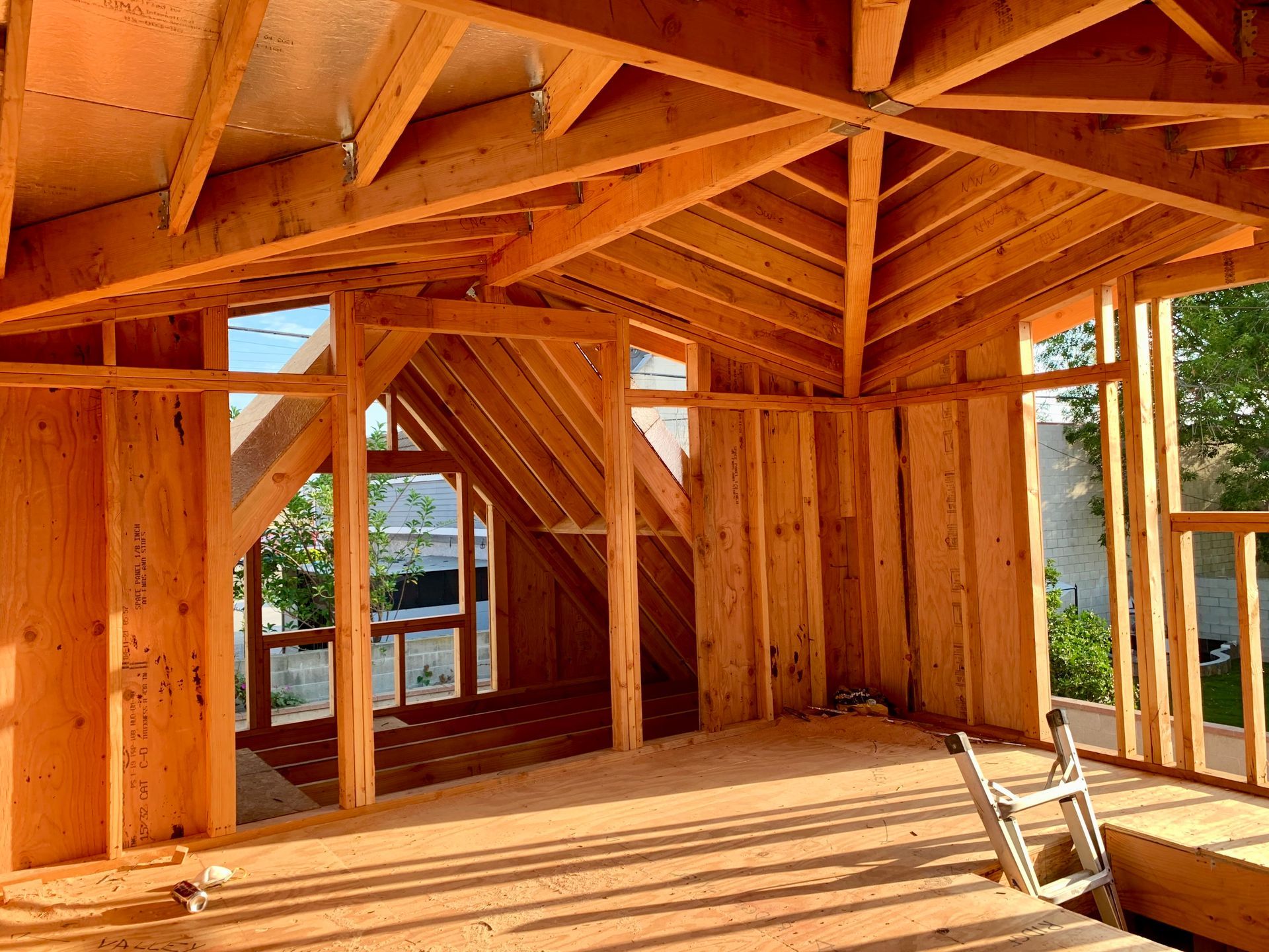 Interior of a building under construction with exposed wooden framework and partial walls.