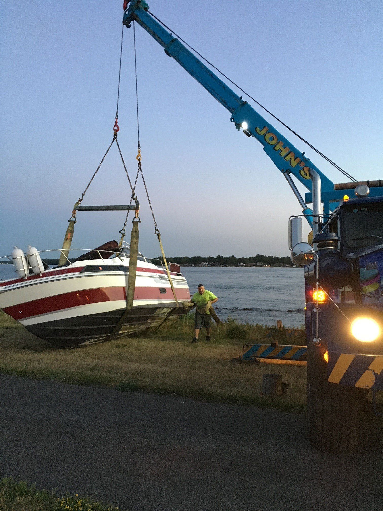 Truck Lifting The Boat — Buffalo, NY — John’s Towing & Storage