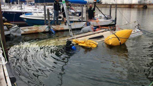 Worker Lifting The Boat — Buffalo, NY — John’s Towing & Storage