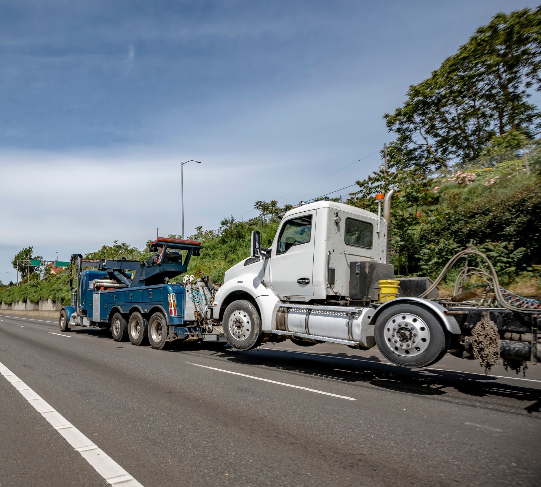 John’s Towing truck providing heavy duty towing for a broken-down truck in Buffalo, NY