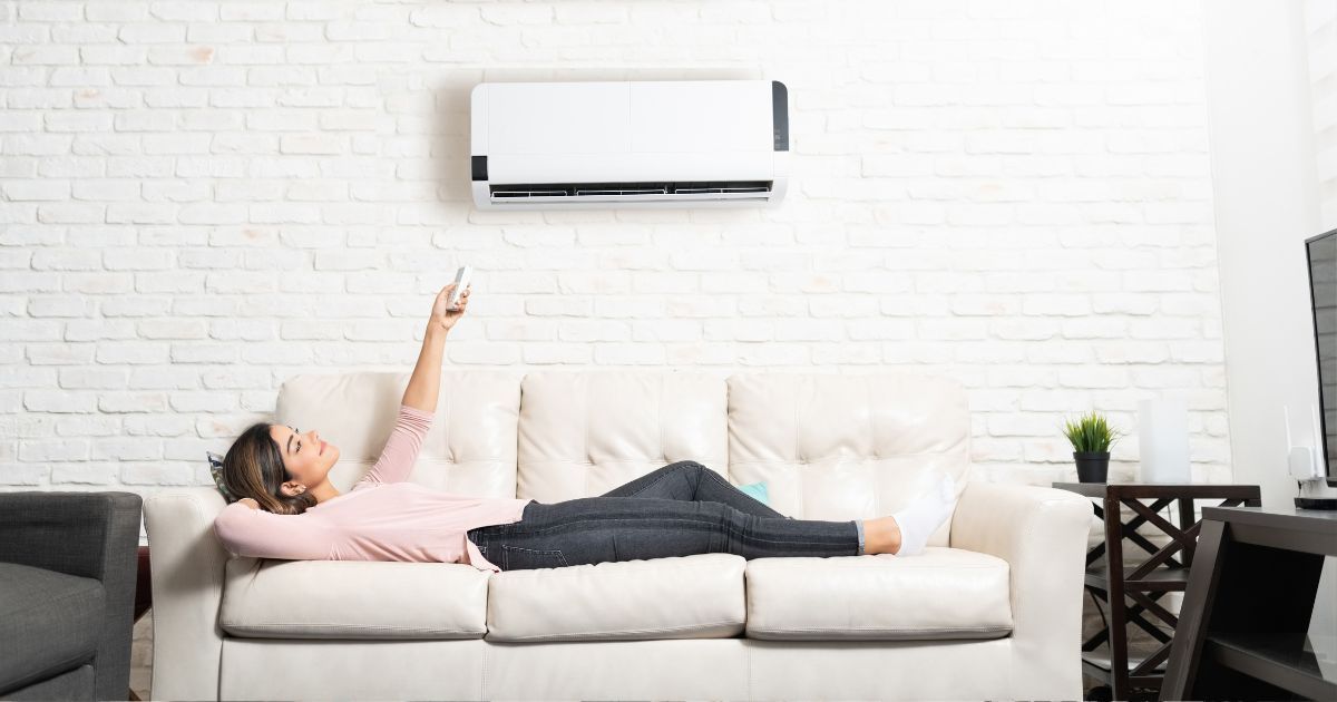 woman enjoying air conditioner 