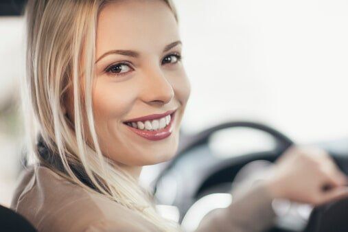 Smiling Woman Driving — Essential Homeowners and Car Insurance in Temecula, CA