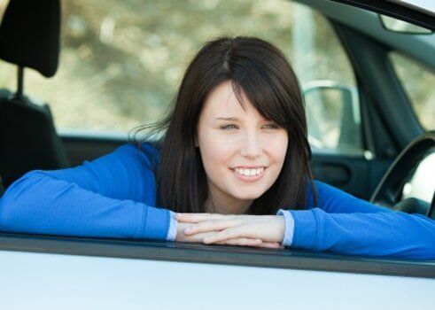 A woman in her car after meeting a car insurance agent in Temecula, CA