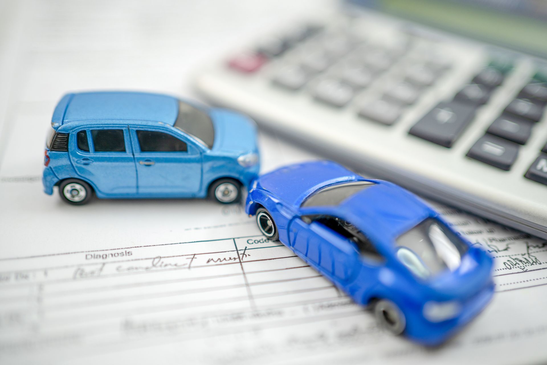 Two toy cars colliding as a concept for car insurance.