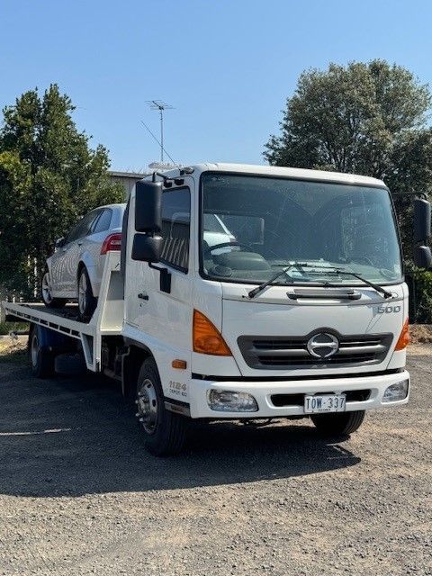 A Tow Truck Is Carrying a Car on The Back of It — Lorne Breakdown and Towing Service in Lorne, VIC