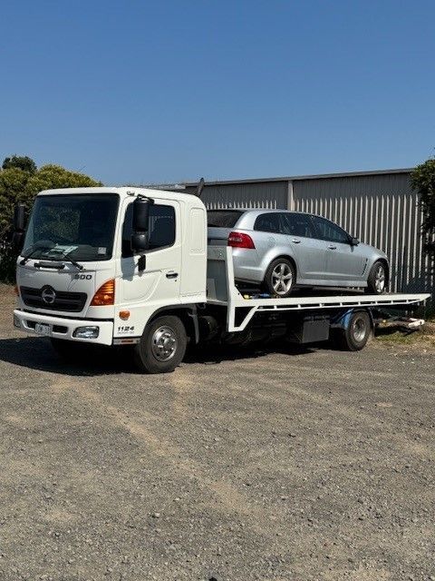 A White Tow Truck with A Car on The Back — Lorne Breakdown and Towing Service in Lorne, VIC
