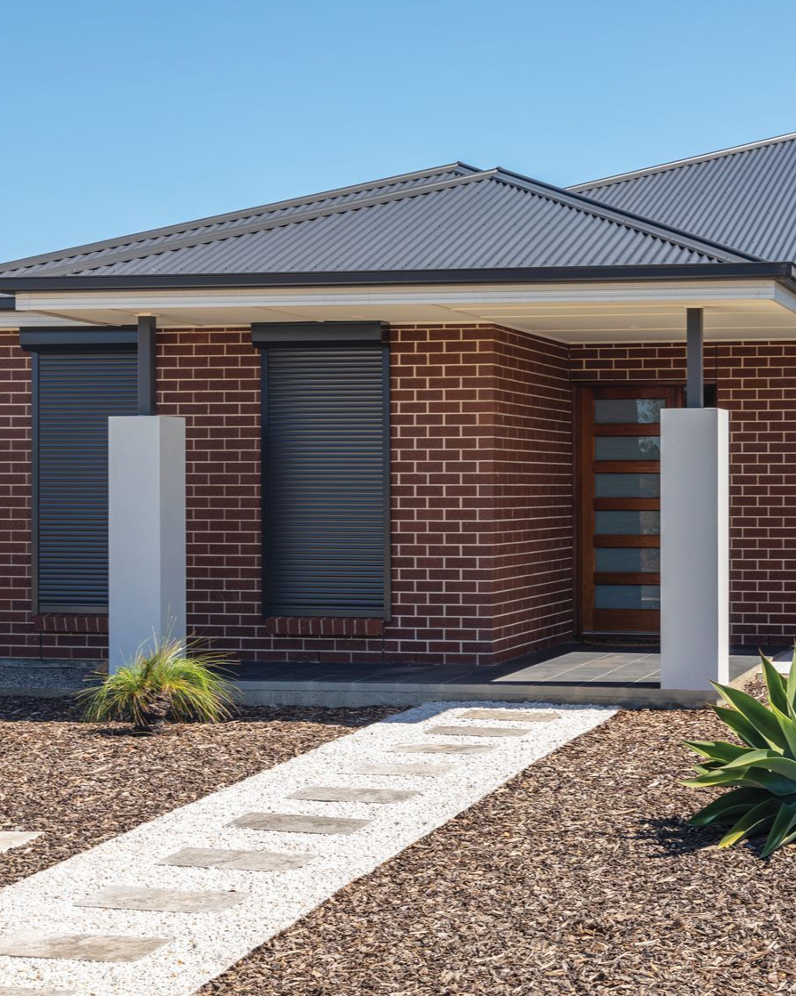 Premium roller shutters installed on modern home providing security, insulation, and weather protection