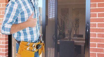 Home entrance with a newly installed steel mesh security screen door showcasing its sturdy design and locking mechanism.
